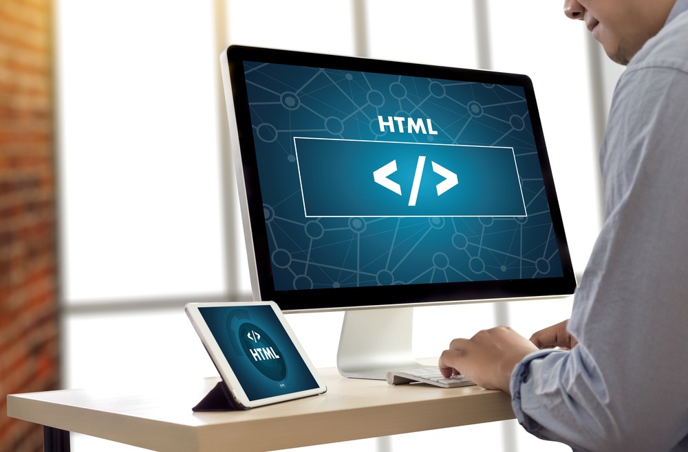 man using laptop coding html